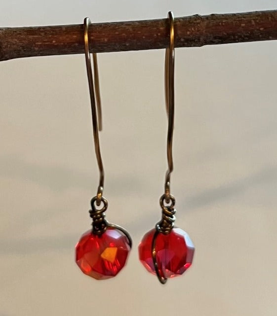 RED BEADED EARRINGS, ANTIQUE BRONZE HAND WRAPPED WIRES.